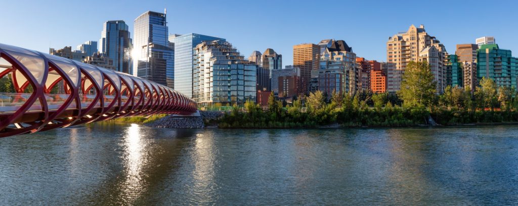 Peace Bridge across Bow River during a vibrant summer sunrise